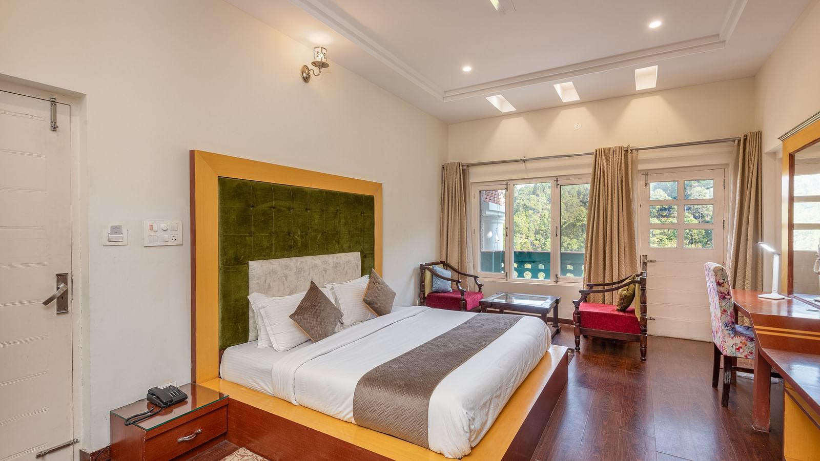 Comfortable and inviting room at DLS Tehri Club Resort with a warm colour scheme and hardwood floors.